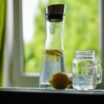 Acqua e limone in un bicchiere, simbolo di disintossicazione del fegato e salute naturale.