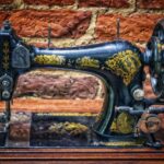 Vecchia macchina da cucire vintage su un tavolo di legno, simbolo di artigianato e storia.